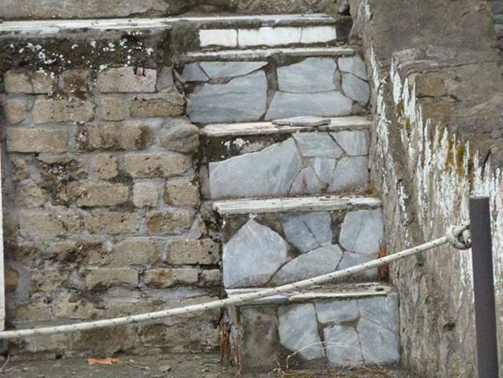 Herculaneum, September 2015. Sacred Area terrace, steps on east end of the shrine of the four gods. Originally it is thought the shrine would have had steps at either end of the podium, but at the west end the podium had been damaged by a Bourbon tunnel.
